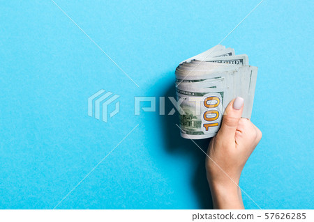 Female hand holding tightly a bundle of money. Top Female hand holding tightly a bundle of money. Top 57626285