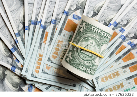 Top view of 1 rolled dollar bills on background Top view of 1 rolled dollar bills on background 57626328