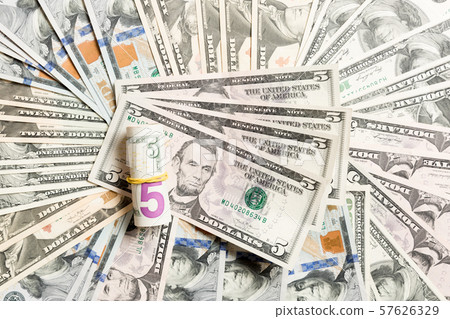 Close up of 5 dollar bills pile on background made Close up of 5 dollar bills pile on background made 57626329