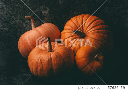 Photo of four orange pumpkins on black background, halloween celebration, space for inscription. Photo of four orange pumpkins on black background, halloween celebration, space for inscription. 57626459