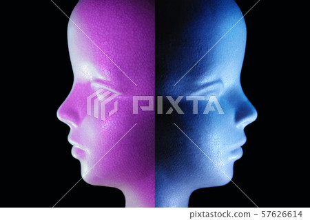 Side profile of a styrofoam doll illuminated with blue and purple light and black copy space 57626614