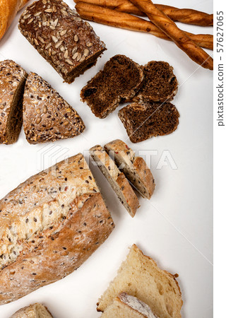 Different types of bread on a white background. Top view. Different types of bread on a white background. Top view. 57627065