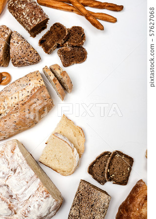 Different types of bread on a white background. Top view. Copy space. Different types of bread on a white background. Top view. Copy space. 57627068