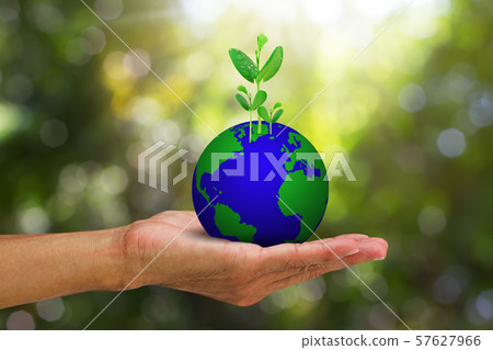 Hand holding globe with green sprout on blurred Hand holding globe with green sprout on blurred 57627966