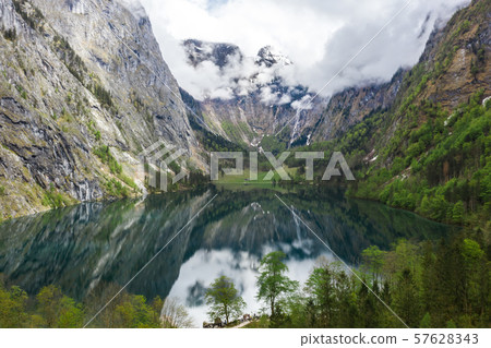 Scenic mountain panorama with green meadows and idyllic turquoise Lake Oberer Scenic mountain panorama with green meadows and idyllic turquoise Lake Oberer 57628343