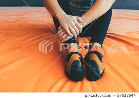 Foot in sports shoes and hands. Foot in sports shoes and hands. 57628644