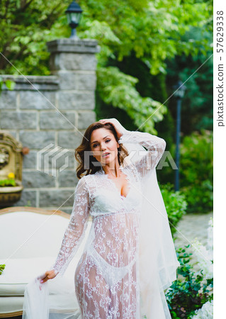 Close-up portrait of young beautiful bride with big piece of white fabric 57629338