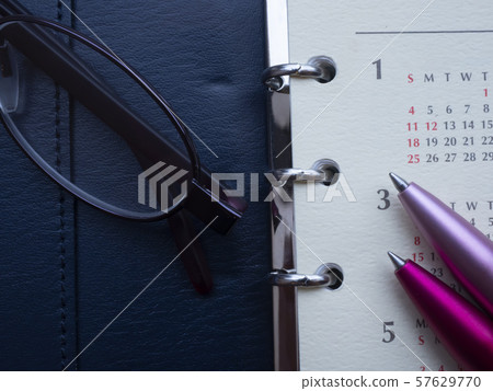Business image · notebook · calendar · glasses · female 57629770