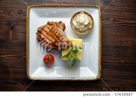 Steak on the bone with red sauce. restaurant menu 57630987