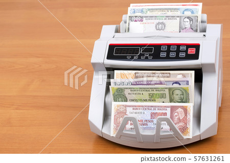 Old Bolivian Boliviano in a counting machine 57631261