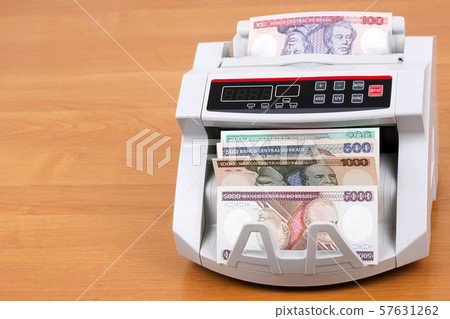 Old Brazilian money in a counting machine 57631262