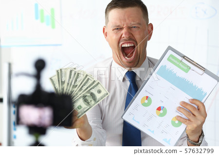 Angry businness vlogger hold in hands dollars 57632799