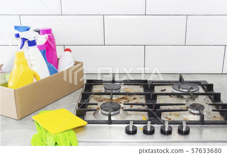 Cleaning a gas stove with kitchen utensils, Cleaning a gas stove with kitchen utensils, 57633680