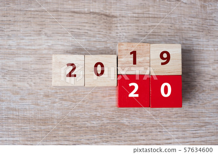 wooden cube with flip over block 2019 to 2020 word on table background. Resolution, strategy, solution, goal, business, New Year New You and happy holiday concepts wooden cube with flip over block 2019 to 2020 word on table background. Resolution, strategy, solution, goal, business, New Year New You and happy holiday concepts 57634600