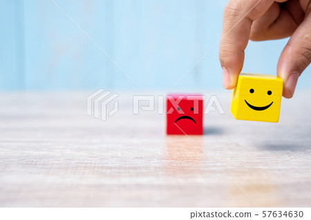 smiley face on yellow wood cube and sad face icon smiley face on yellow wood cube and sad face icon 57634630