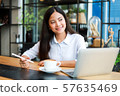 Asian woman in cafe 57635469