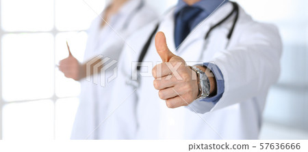 Group of doctors showing thumbs up. Perfect medical service in clinic. Happy future in medicine and Group of doctors showing thumbs up. Perfect medical service in clinic. Happy future in medicine and 57636666