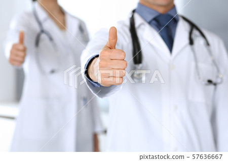Group of doctors showing thumbs up. Perfect medical service in clinic. Happy future in medicine and Group of doctors showing thumbs up. Perfect medical service in clinic. Happy future in medicine and 57636667