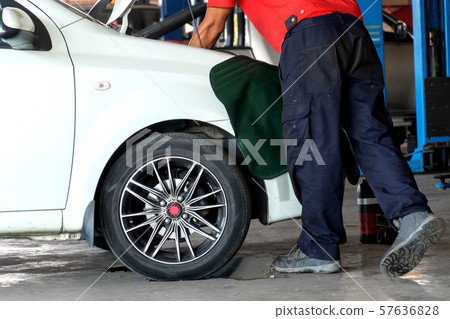 Mechanic repairs car and maintains vehicle  57636828
