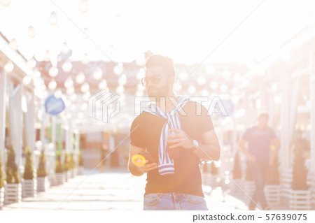 Cute stylish arab young male hipster with a mustache and a beard and wearing glasses drinking juice Cute stylish arab young male hipster with a mustache and a beard and wearing glasses drinking juice 57639075