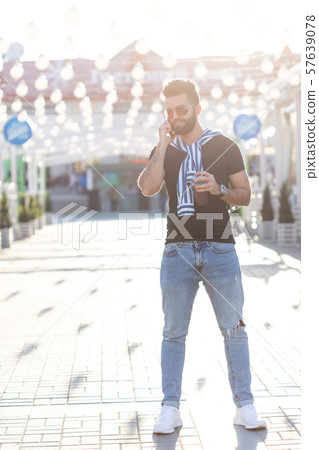 Portrait of a stylish young hipster arab male with juice. Urban holiday at the weekend concept. Portrait of a stylish young hipster arab male with juice. Urban holiday at the weekend concept. 57639078