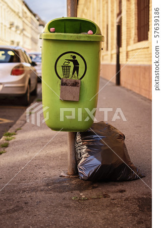 Green garbage bin from the street with extra Green garbage bin from the street with extra 57639186
