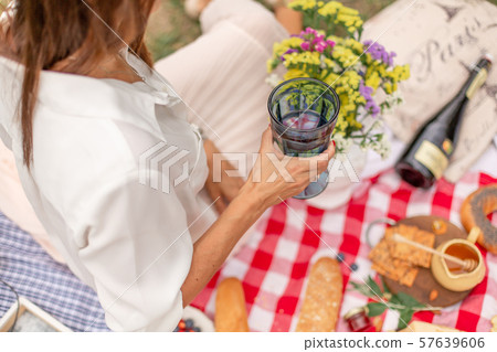 Young brunette woman enjoy outdoor picnic on green 57639606