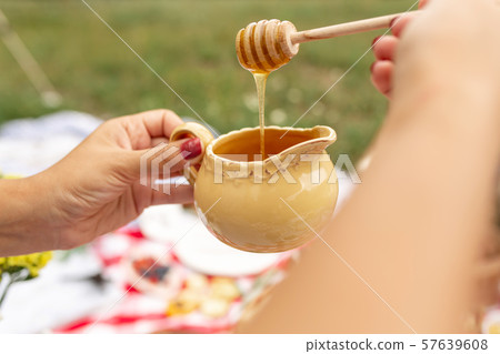 Woman drip honey on sandwich with parma and cheese 57639608