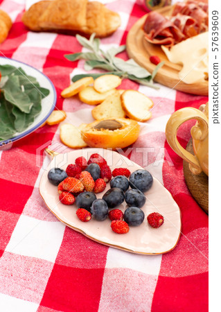 Stylish picnic on the green lawn. Fresh croissants 57639609