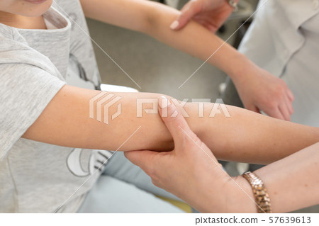 doctor dermatologist makes the initial examination 57639613