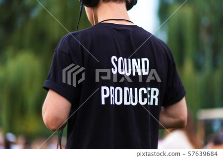 Technician guy in headphones and t-shirt with the Technician guy in headphones and t-shirt with the 57639684