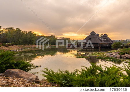 Sunset in a picturesque place. Wooden house near Sunset in a picturesque place. Wooden house near 57639686