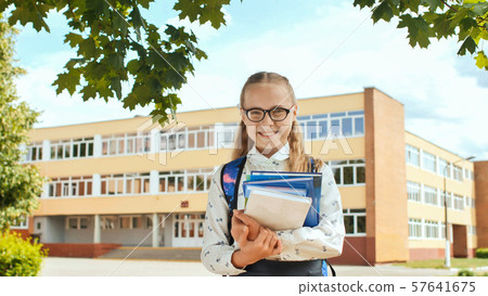 Portrait of smiling school girl child with backpack and books. Portrait of smiling school girl child with backpack and books. 57641675