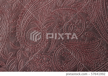 Texture of genuine leather close-up, burgundy color with embossed floral trend pattern, for Texture of genuine leather close-up, burgundy color with embossed floral trend pattern, for 57641992