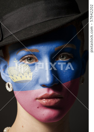 Woman face with painted Flag of Liechtenstein 57642202