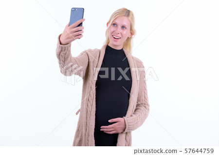 Happy young beautiful blonde pregnant woman taking selfie 57644759