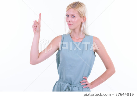 Portrait of young beautiful blonde woman pointing up 57644819
