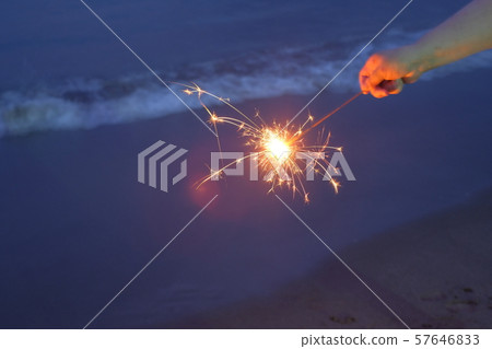 Hand held fireworks at the sea 57646833