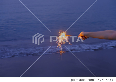 Hand held fireworks at the sea 57646835