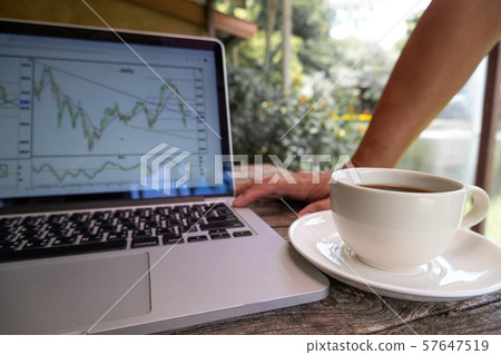 Trader man drink black coffee and pointing tactical move, strategy analysis of stock graph Trader man drink black coffee and pointing tactical move, strategy analysis of stock graph 57647519
