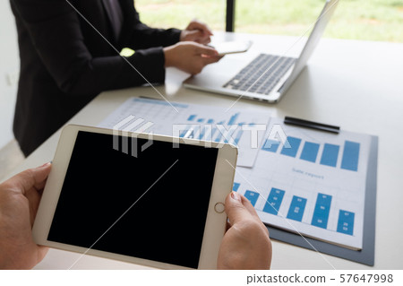 Two business leader women discussing the charts, graphs and showing the results for planning management new project Two business leader women discussing the charts, graphs and showing the results for planning management new project 57647998