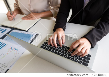 Two business leader women discussing the charts, graphs and showing the results for planning management new project Two business leader women discussing the charts, graphs and showing the results for planning management new project 57648002