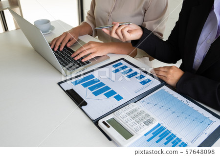 Two business leader women discussing the charts, graphs and showing the results for planning management new project 57648098