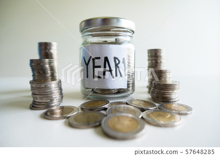 Glass bottle piggy bank education save plan with coin pile, step up growing business to success and saving for retirement concept 57648285