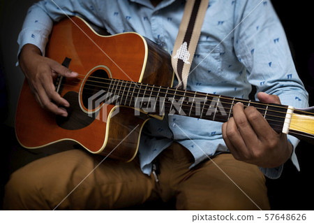 Male Guitar Musician Playing His Acoustic Guitar 57648626