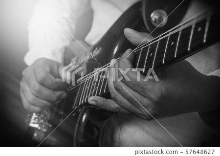 Male Guitar Musician Playing His Electric Guitar Male Guitar Musician Playing His Electric Guitar 57648627