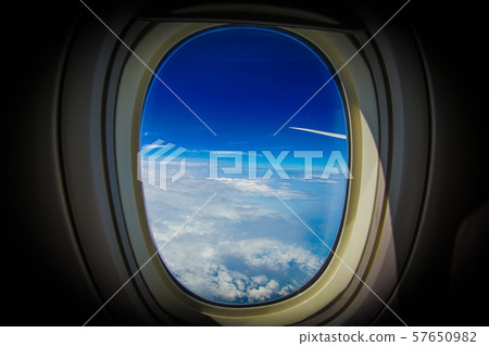 Clouds and sky seen from airplane window Clouds and sky seen from airplane window 57650982