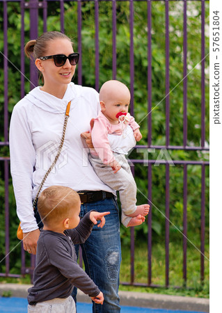 Young mother with children on playground Young mother with children on playground 57651804