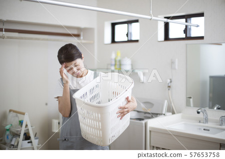 Housewife suffering from headaches 57653758