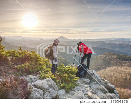 Photographer with tripod and camera on cliff and Photographer with tripod and camera on cliff and 57654176